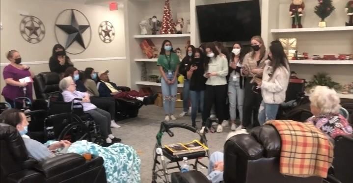 students caroling at a retirement home